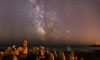 Stone characters under the Milky Way
