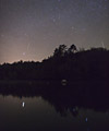 Two Geminids reflect in the water